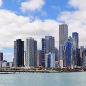 Family Medicine USCE in Chicago An image highlighting the Family Medicine U.S. Clinical Experience (USCE) opportunities in Chicago, showcasing the city's urban skyline with skyscrapers and Lake Michigan under a cloudy blue sky.