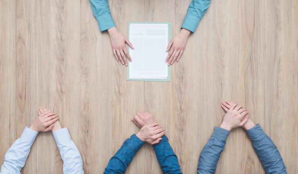 An image of a medical student presenting a project in a classroom setting, with colleagues and a professor attentively listening. This image reflects the dynamic and interactive learning environment fostered by The Match Guy services.